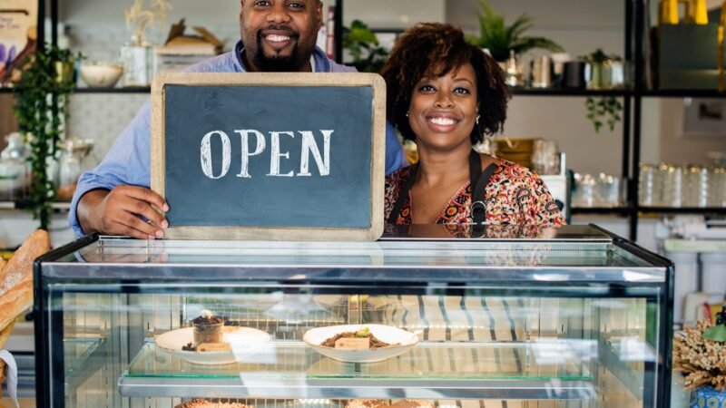 cake-cafe-owners-with-open-sign